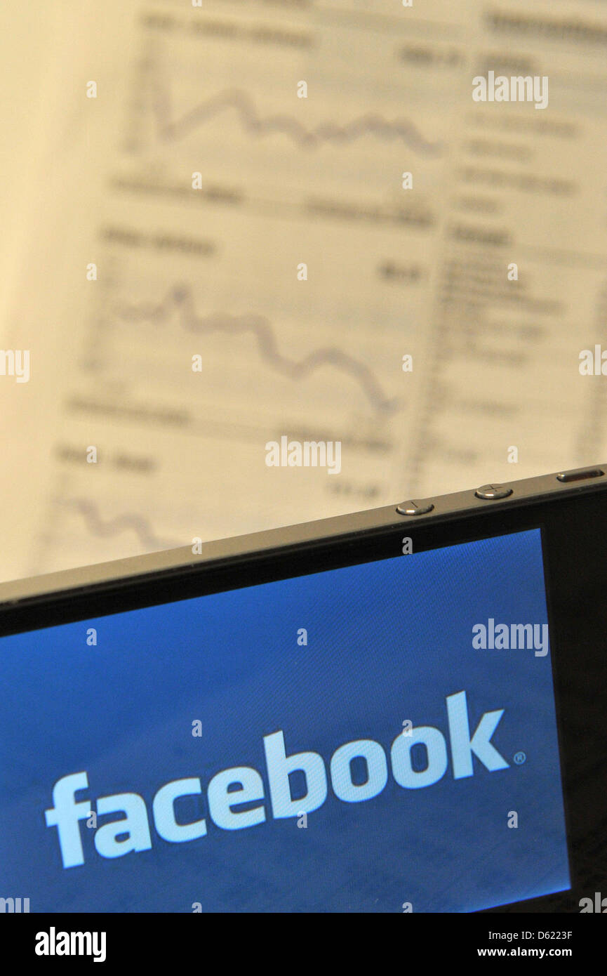 ILLUSTRATION - An illustrated picture shows a smartphone displaying the logo of online social media network  Facebook on its screen while lying on the financial section of a daily newspaper in Berlin, Germany, 08 May 2012. Faceboock stock is expected to start trading at the technology exchange Nasdaq on 19 May 2012. Photo: Marc Tirl Stock Photo