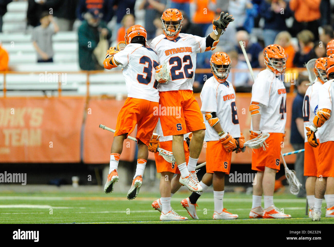 April 10, 2013 - Syracuse, New York, USA - April 10, 2013: Syracuse Orange midfielders JoJo Marasco #22 and Drew Jenkins #37 chest bump prior to the start of an NCAA Lacrosse game between the Cornell Big Red and the Syracuse Orange at the Carrier Dome in Syracuse, New York. Syracuse won the game 13-12. Stock Photo