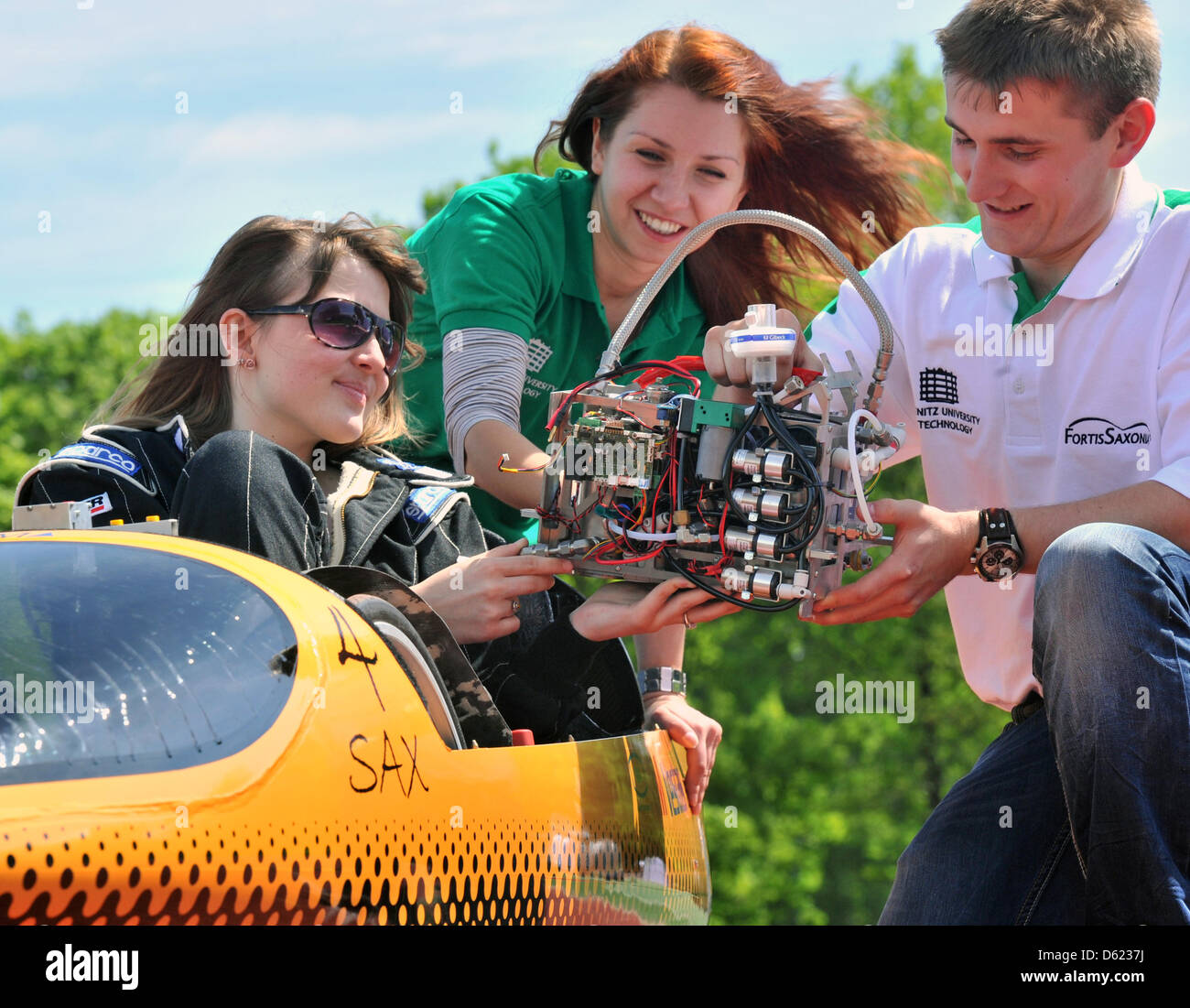 Students Christine (L-R), Anetta and Nico from team Fortis Saxonia of the University of Applied Sciences Chemnitz prepare a test run of their eco-mobile SAX4 in Chemnitz, Germany, 10 May 2012. The students and their futuristic vehicle will take part in the Shell Eco-marathon in Rotterdam from 17 till 19 May 2012. The biggest competition for susatinable mobility inm Europe attracts  Stock Photo