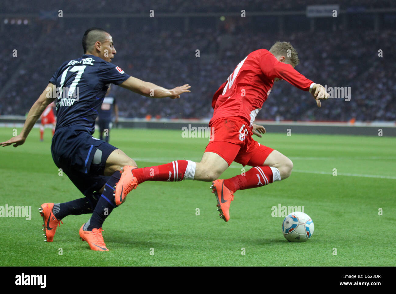 Hertha's Anis Ben-Hatira (L) chases a Duesseldorf player with the ball during the first leg Bundesliga relegation match Hertha Berlin versus Fortuna Duesseldorf at Olympic Stadium in Berlin, Germany, Olympiastadion. Hertha lost the match 1-2. Photo: Kay Nietfeld Stock Photo
