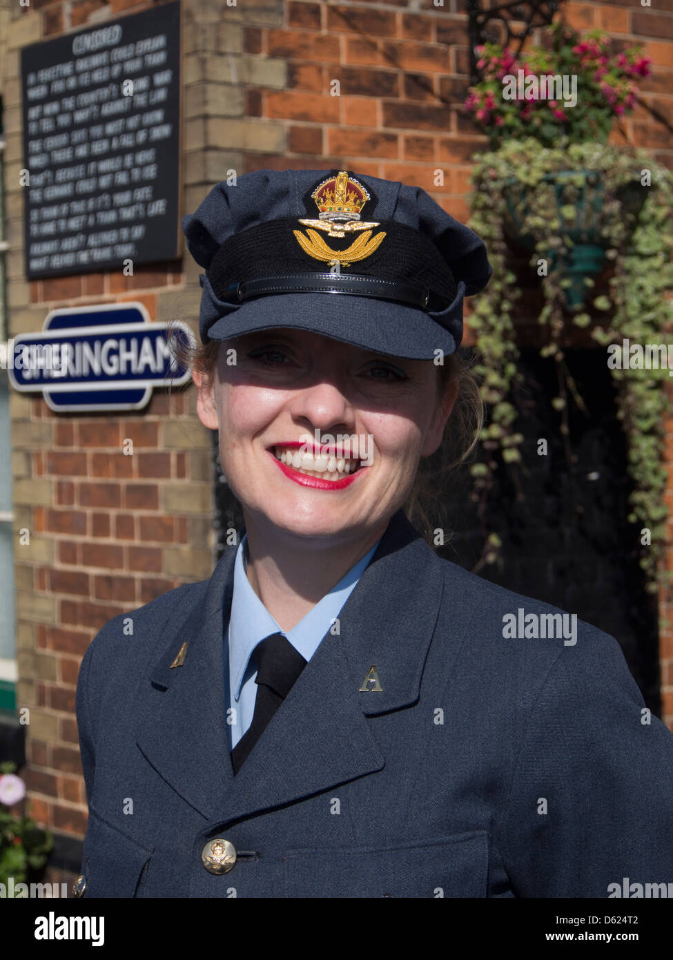 Woman dressed  in  RAF uniform  for 1940s weekend on Sheringham station in Norfolk East Anglia England Stock Photo