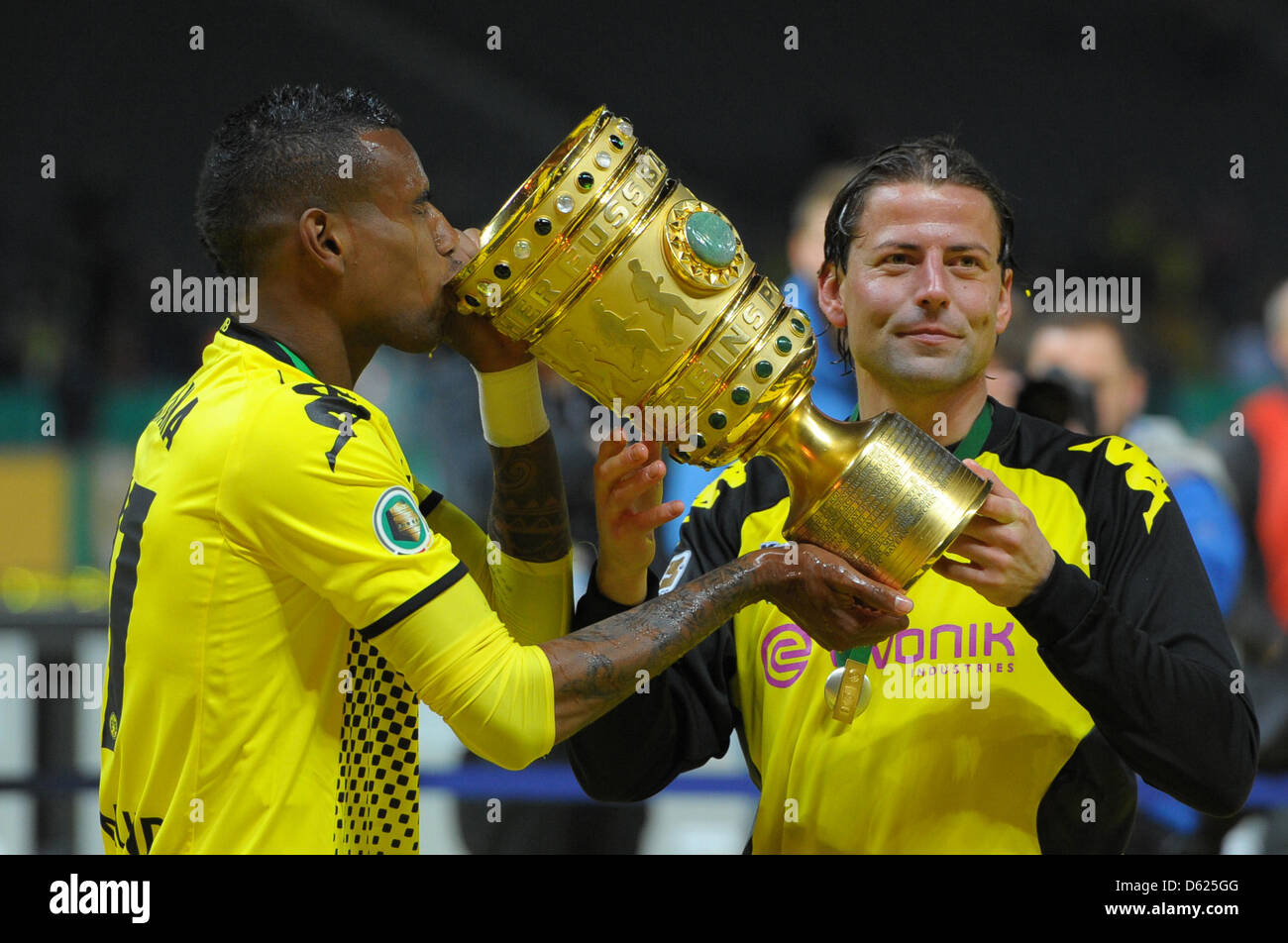 Dortmund's Felipe Santana (L) and goal keeper Roman Weidenfeller (R) celebrate with the trophy after the German DFB Cup final soccer match between Borussia Dortmund and FC Bayern Munich at the Olympic Stadium in Berlin, Germany, 12 May 2012. Photo: Soeren Stache dpa/lbn (ATTENTION: The DFB prohibits the utilisation and publication of sequential pictures on the internet and other on Stock Photo