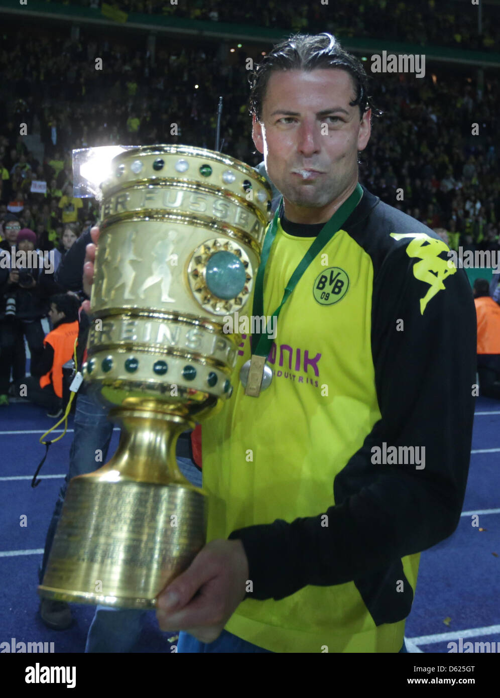 Dortmund's goal keeper Roman Weidenfeller celebrates with the trophy after the German DFB Cup final soccer match between Borussia Dortmund and FC Bayern Munich at the Olympic Stadium in Berlin, Germany, 12 May 2012. Photo: Kay Nietfeld dpa/lbn (ATTENTION: The DFB prohibits the utilisation and publication of sequential pictures on the internet and other online media during the match Stock Photo