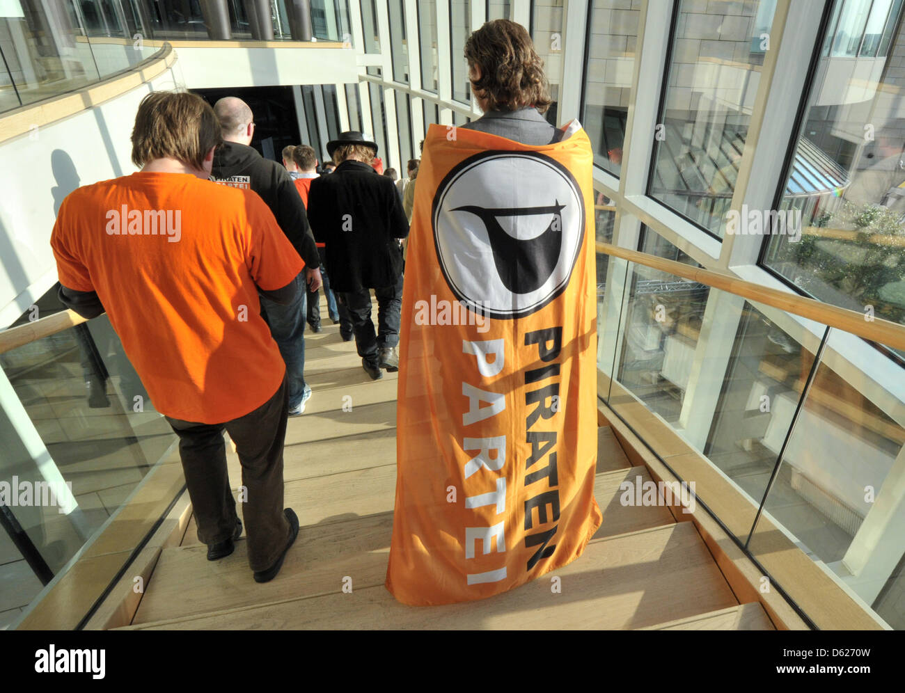 A member of the Pirate Party walks by the state parliament after the announcement of the first projections of the results of the state elections in North Rhine-Westphalia in Duesseldorf, Germany, 13 May 2012. The Pirates will enter the parliament of the fourth state in Germany. Photo: BORIS ROESSLER Stock Photo