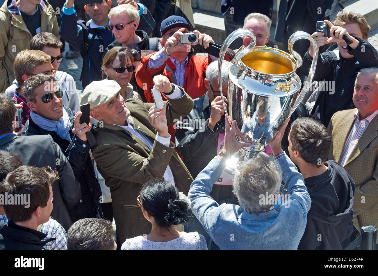 Former Bayern Munich soccer player Paul Breitner holds the UEFA  Champions League Cup during a Champions League Cup bus tour in Munich, Germany, 14 May 2012. The Champions League final match between FC Bayern Munich and Chelsea FC will take place on 19 May 2012. Photo: PETER KNEFFEL Stock Photo
