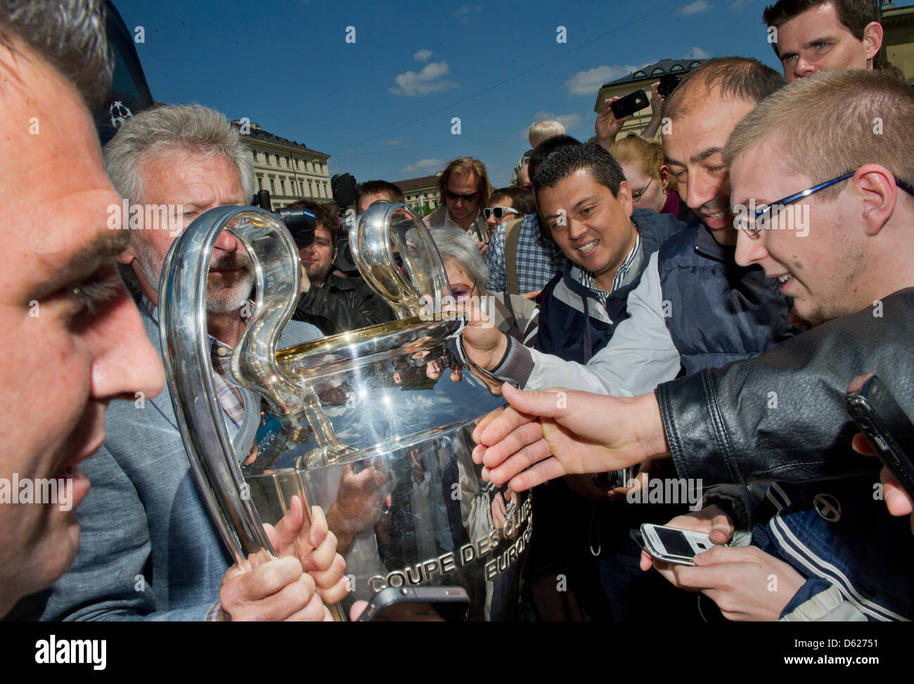 Former Bayern Munich soccer players Paul Breitner (L) presents the UEFA Champions League Cup during a Champions League Cup bus tour in Munich, Germany, 14 May 2012. The Champions League final match between FC Bayern Munich and Chelsea FC will take place on 19 May 2012. Photo: PETER KNEFFEL Stock Photo