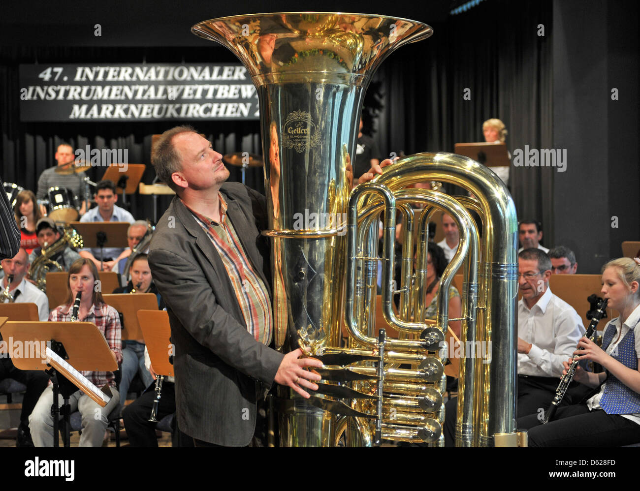 Joerg Wachsmuth from Dresden plays 'Flight of the Bumblebee' on the world's biggest playable tuba with the symphony orchestra of Markneukirchen inMarkneukirchen, Germany, 15 May 2012. The tuba is 2 meters high, weighs arounf 50 kg and has a bell with a 1 m diameter, making it roughly twice as big as an ordinary sized tuba. Photo: HENDRIK SCHMIDT Stock Photo