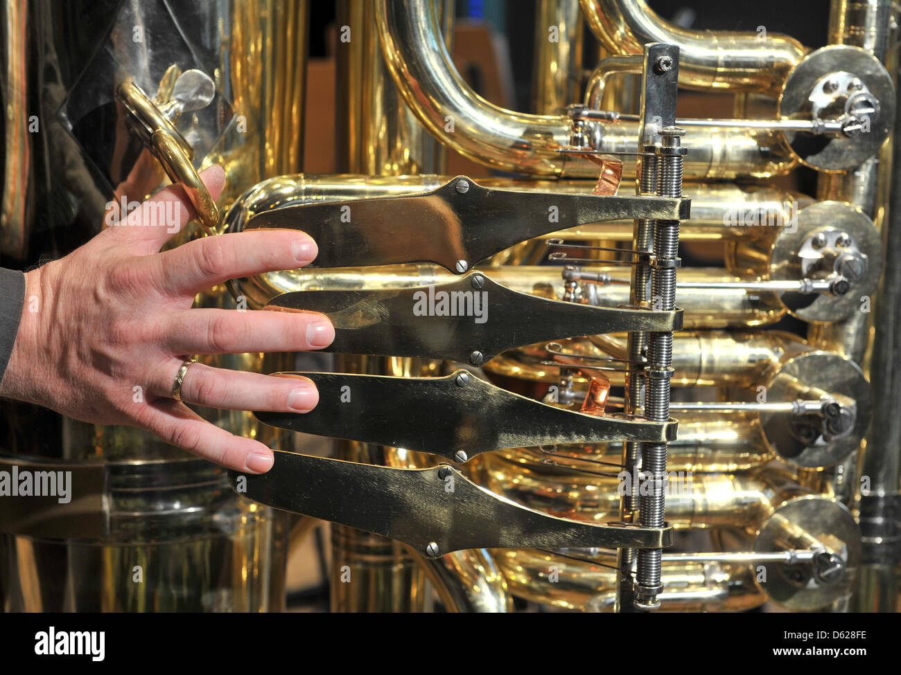 Joerg Wachsmuth from Dresden plays 'Flight of the Bumblebee' on the world's biggest playable tuba with the symphony orchestra of Markneukirchen inMarkneukirchen, Germany, 15 May 2012. The tuba is 2 meters high, weighs arounf 50 kg and has a bell with a 1 m diameter, making it roughly twice as big as an ordinary sized tuba. Photo: HENDRIK SCHMIDT Stock Photo
