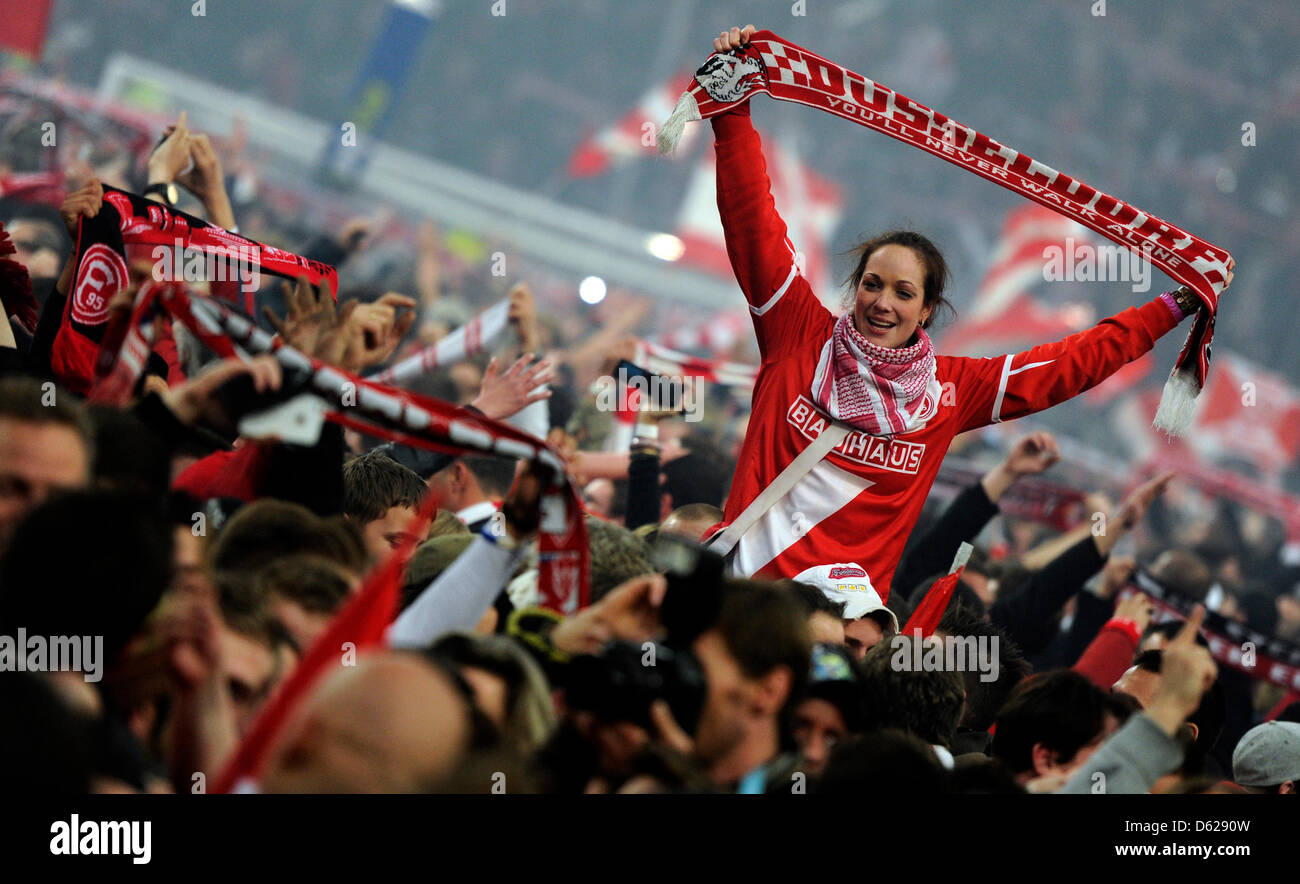 Fans of Bundesliga soccer club Fortuna Duesseldorf run onto the pitch as  they cheer and celebrate after the Bundesliga relegation soccer match  between Fortuna Duesseldorf and Hertha BSC at the Esprit-Arena in