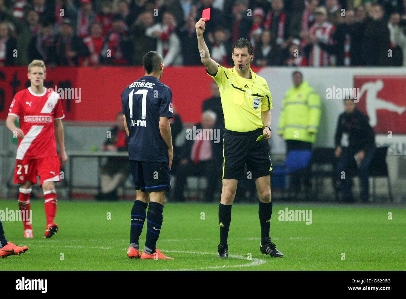 Referee Wolfgang Stark (R) shows Berlin's Anis Ben-Hatira the red card during the Bundesliga relegation soccer match between Fortuna Duesseldorf and Hertha BSC at the Esprit-Arena in Duesseldorf, Germany, 15 May 2012. Photo: Revierfoto Stock Photo
