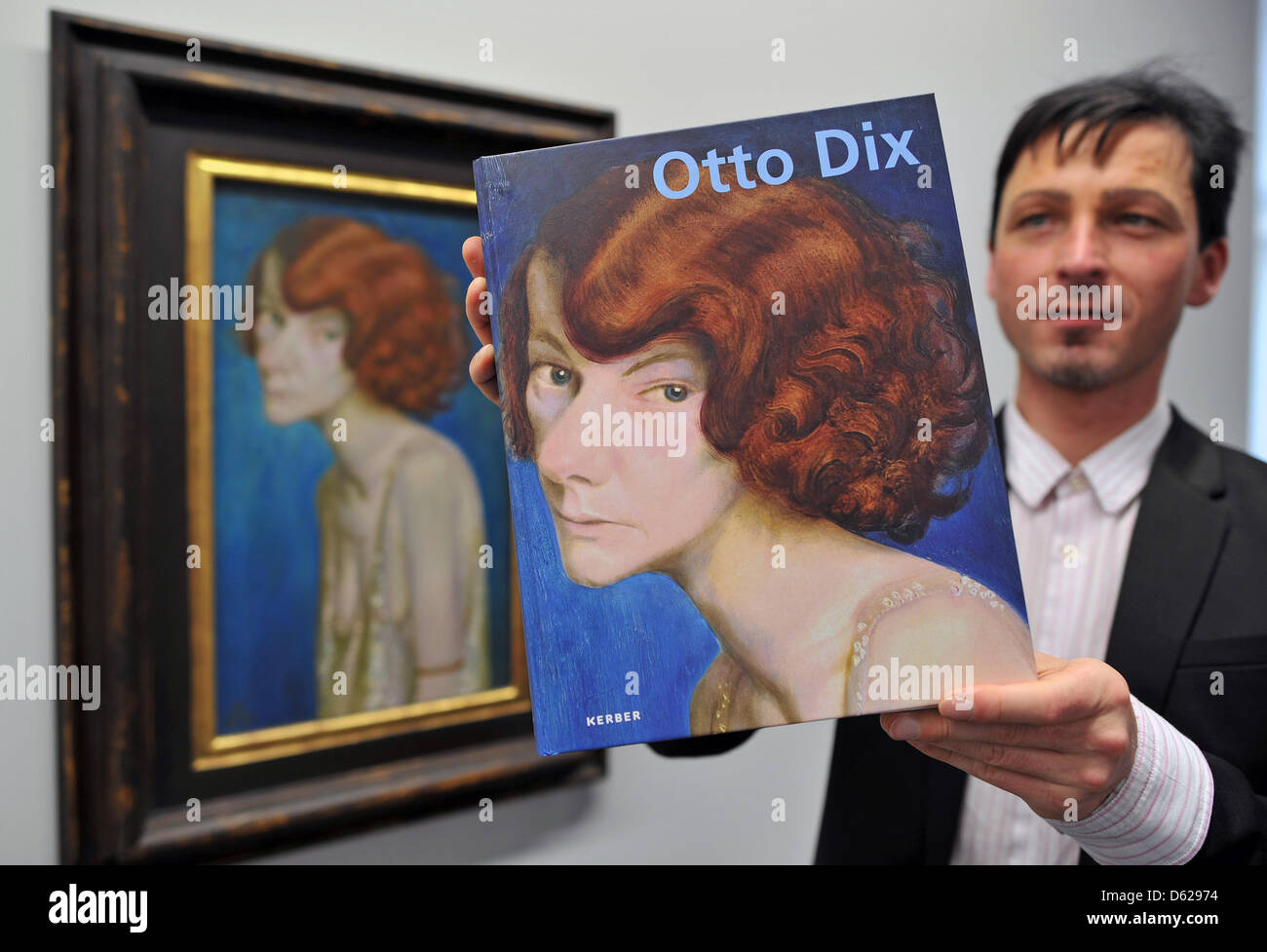 The curator of the Gunzenhauser Collection at the Kunstsammlungen Chemnitz, Thomas Bauer-Friedrich, presents the new catalogue of the entire Otto Dix collection in Chemnitz, Germany, 16 May 2012. The cover is 'Red-haired Woman' from 1931. The museum has collected its entire Dix collection into a new catalogue. The museum has one of the most important and largest Otto Dix collection Stock Photo