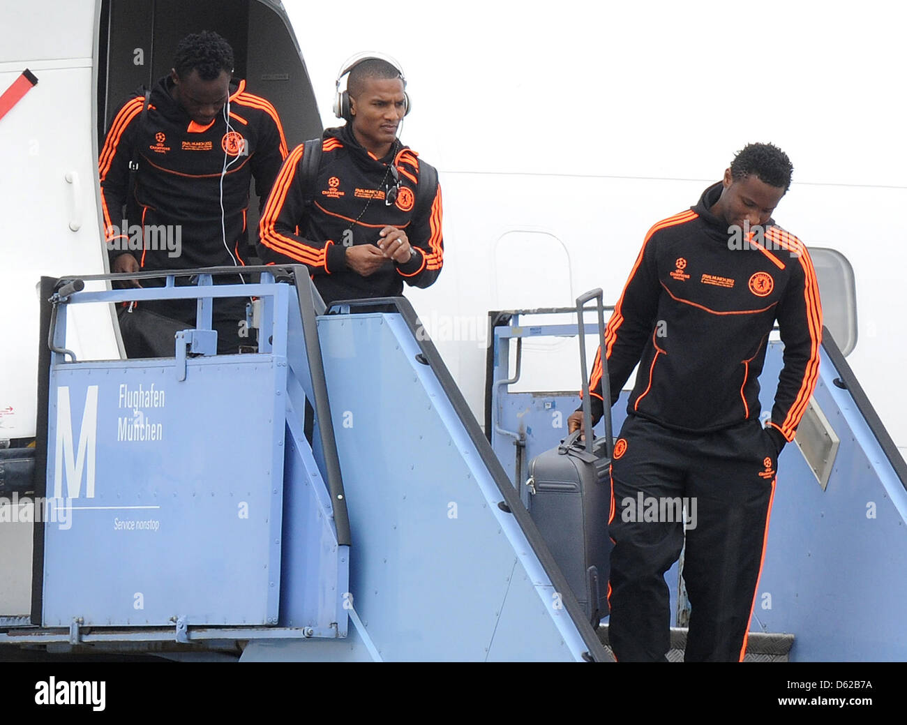 Chelsea's players Michael Essien (L), Florent Malouda (C) and John Obi Mikel (R) arrive at Munich Airport, Germany, 18 May 2012. FC Chelsea will face FC Bayern Munich in the UEFA Champions League soccer final in Munich on 19 May 2012. Photo: Marc Mueller dpa/lby  +++(c) dpa - Bildfunk+++ Stock Photo