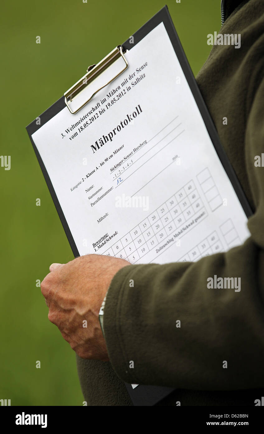 A referee holds tally sheet for the scythe world championships in Salbitz, Germany, 18 May 2012. Arond 230 participants from Germany and abroad are taking part in the event. Photo: JAN WOITAS Stock Photo