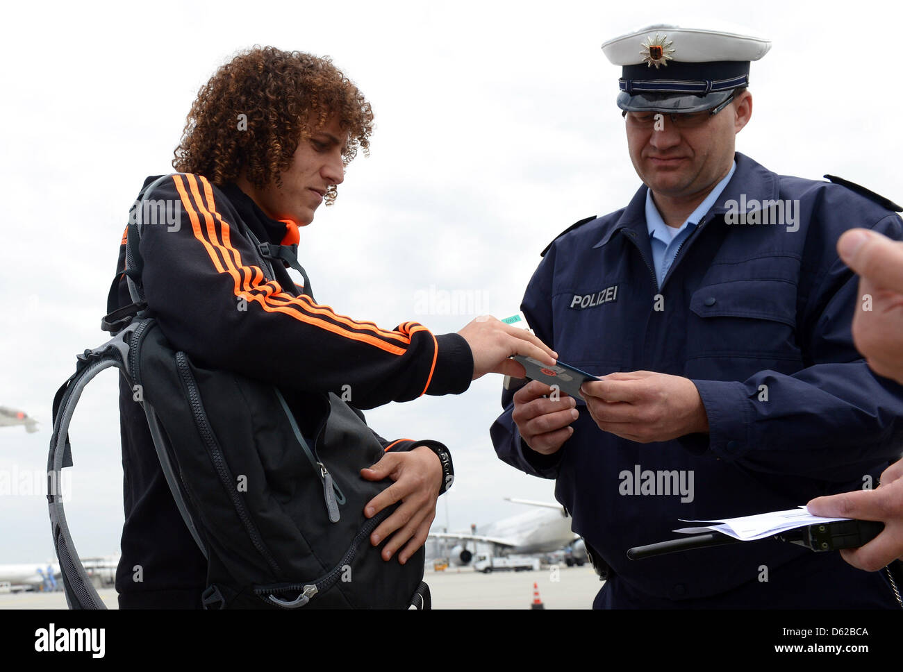MUNICH, GERMANY - MAY 18: German police checks the passport of David ...