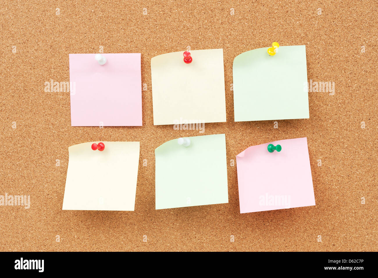 Group of thumbtack and note paper on corkboard Stock Photo