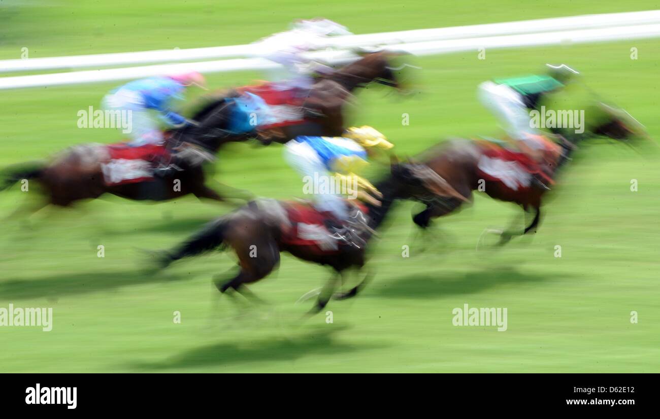 Equestrians in action at the horse race track Iffezheim on the last day of the Spring Meeting in Iffezheim, Germany, 20 May 2012. (pictured with long-time exposure) Photo: PATRICK SEEGER Stock Photo