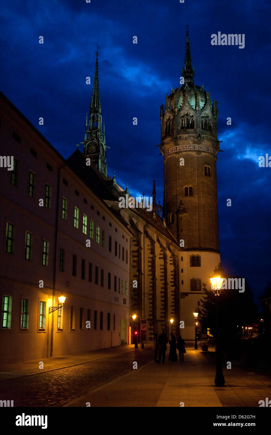 Illuminated facade and towers of St. Mary's Town Church at dusk in