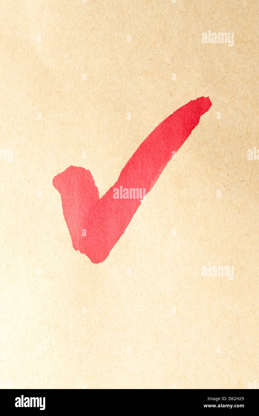 Check mark symbol written on brown paper Stock Photo