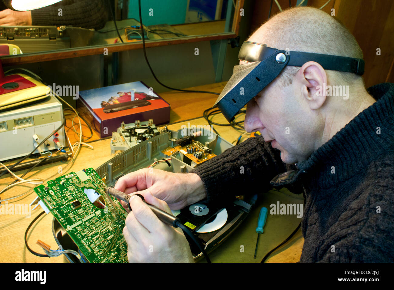 repairman solder chip Stock Photo