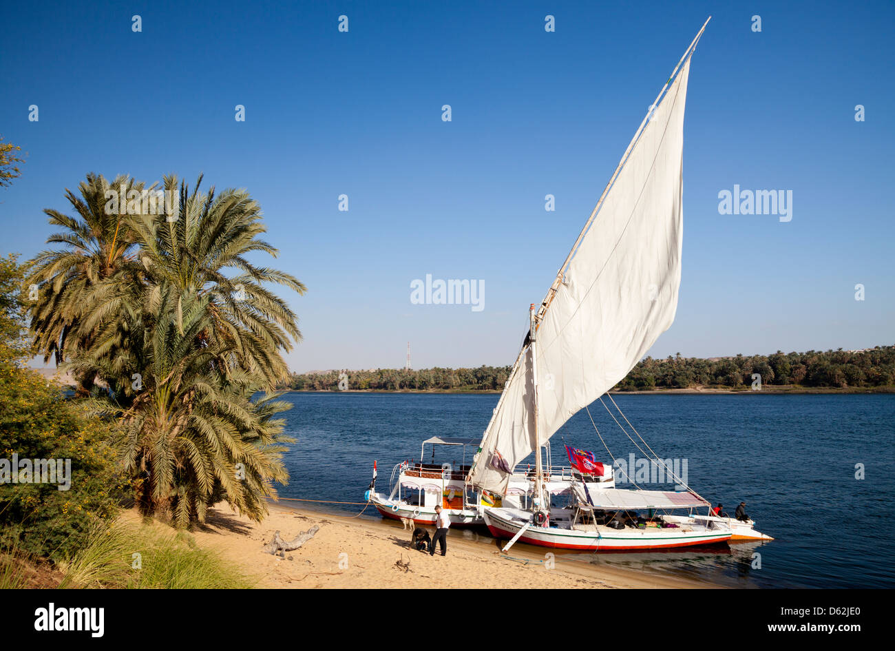 Traditional felucca sailboat moored on the banks of the Nile between Aswan and Luxor in Egypt Stock Photo