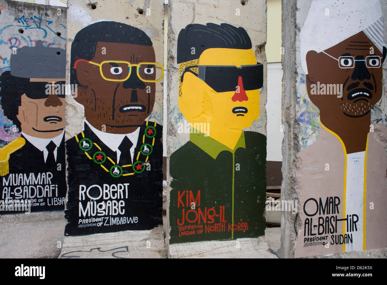 World dictators adorn old sections of the old Berlin Wall opposite the former Checkpoint Charlie, the former border between Communist East and West Berlin during the Cold War. The Berlin Wall was a barrier constructed by the German Democratic Republic (GDR, East Germany) starting on 13 August 1961, that completely cut off (by land) West Berlin from surrounding East Germany and from East Berlin. .. (More in Description). Stock Photo