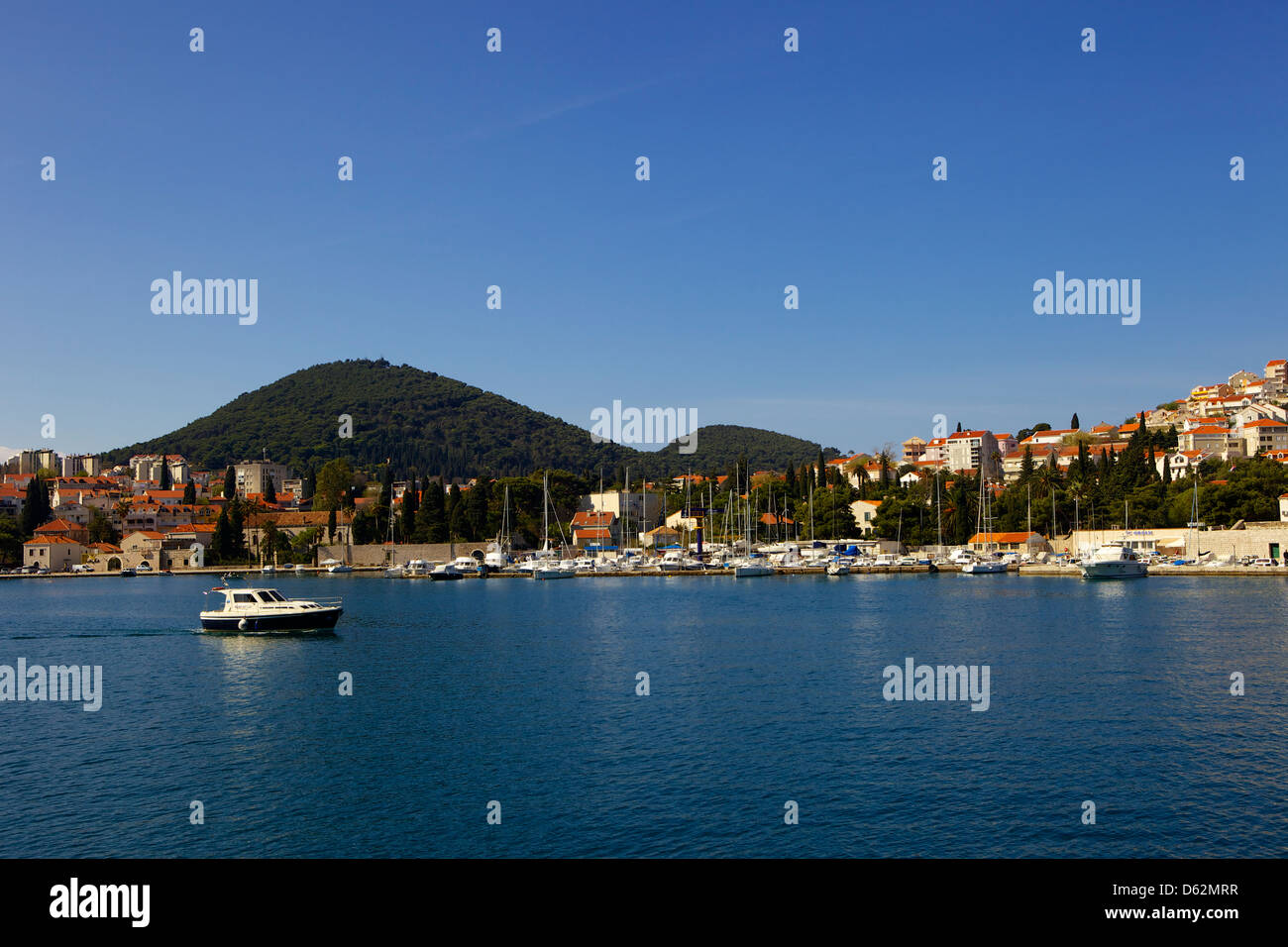 Villas along the coast. And hilltops in the background. Luka Gruz harbour, Dubrovnik, Croatia, Europe Stock Photo