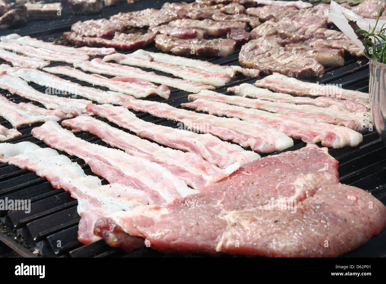 huge outdoor barbecue grill with pork sausage and beacon Stock Photo