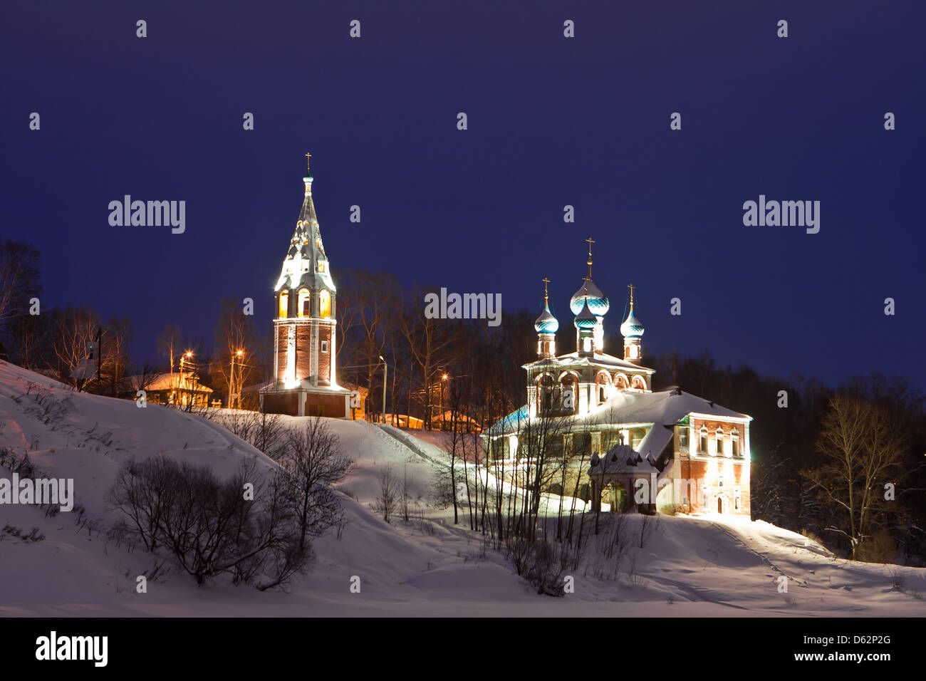 Brightly illuminated church on the bank of the frozen river Stock Photo ...