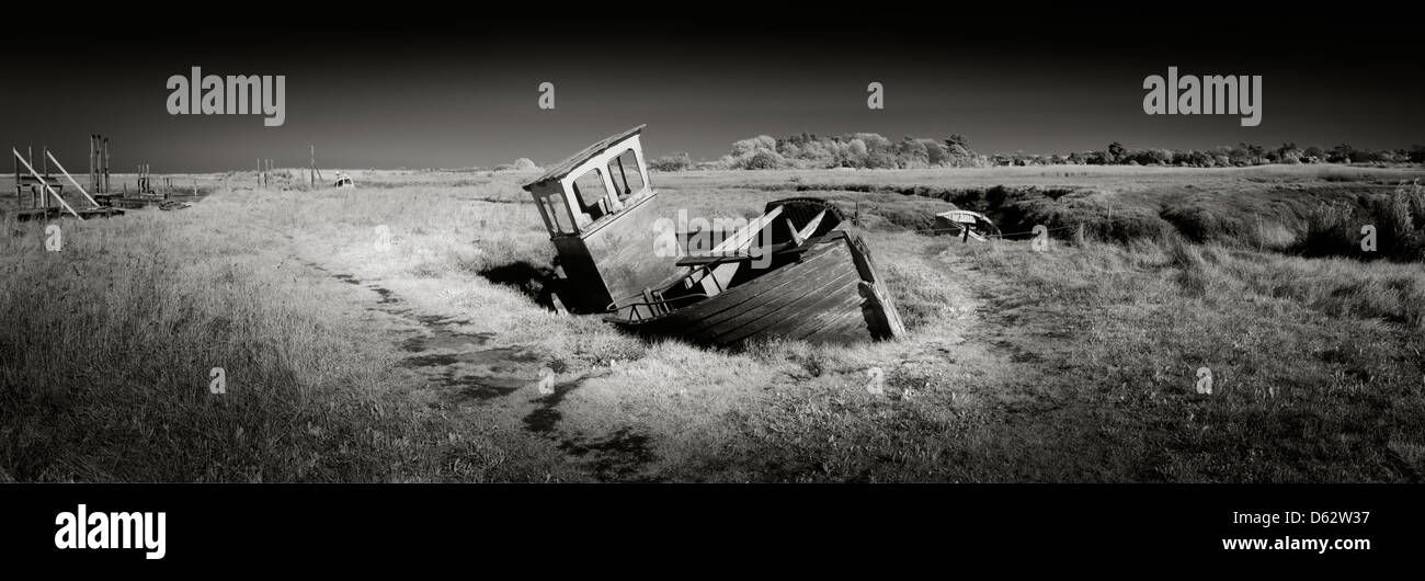 Panoramic view of old wooden fishing boat washed up on the salt marshes at thornham in Panoramic view of old wooden fishing boat washed up on the salt marshes at thornham in