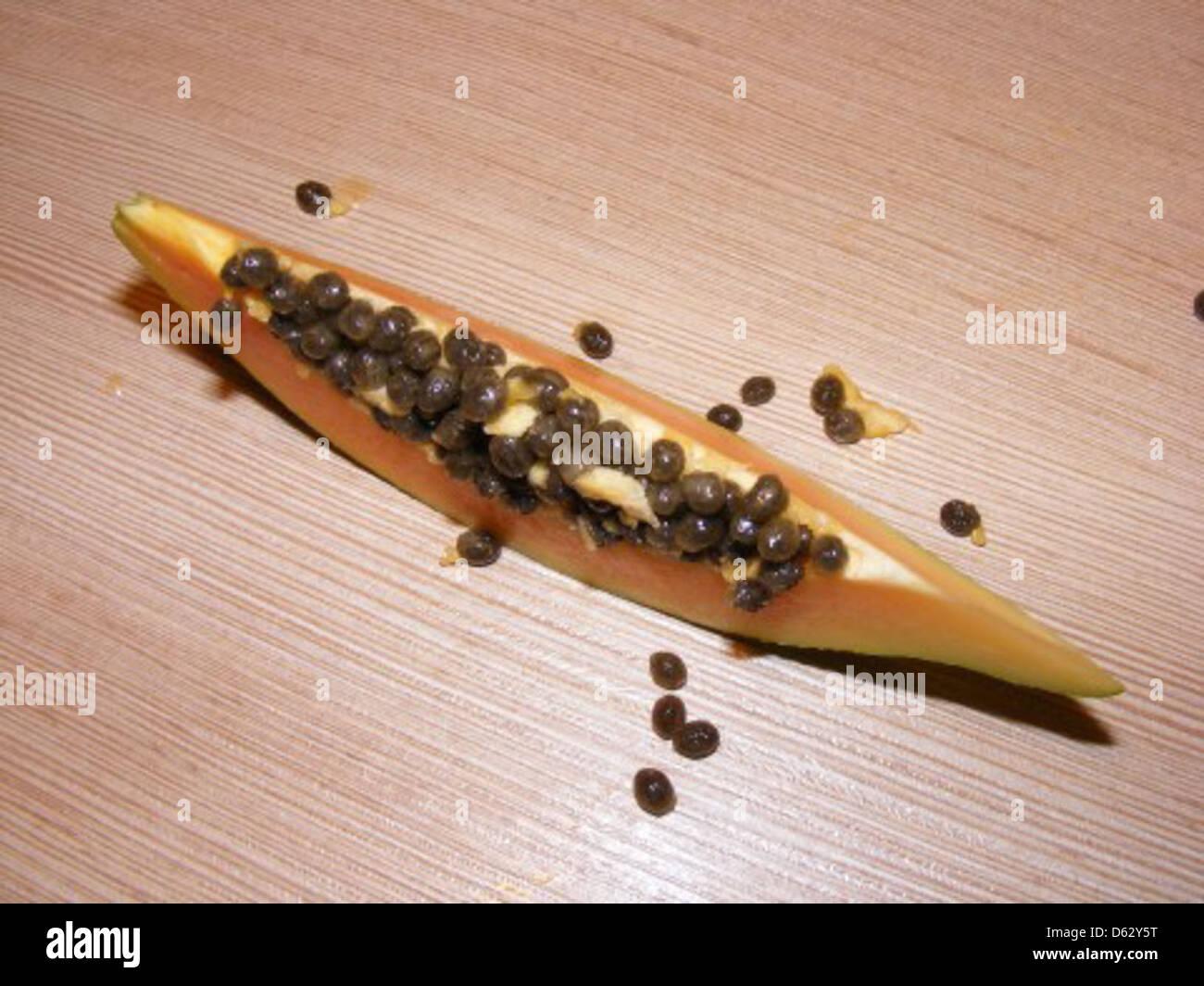 This image features ripe papaya seeds, highlighting their natural form ...