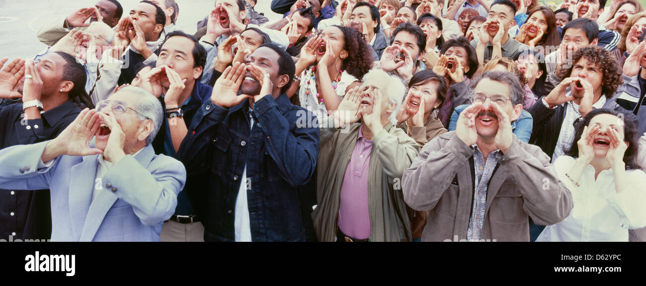 Panoramic shot of crowd shouting with hands face Stock Photo