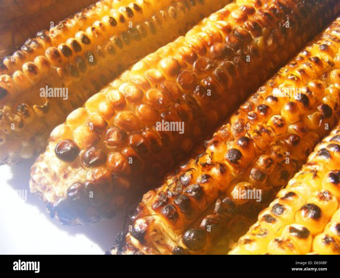 The image shows a close-up of baked corn, showcasing the golden-yellow ...