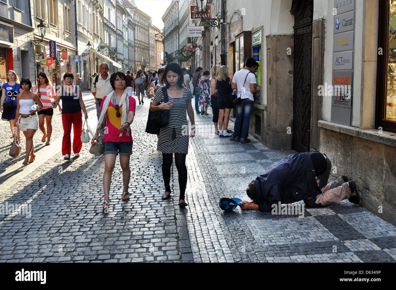 Beggar bows down on his knees on a Prague street, Czech Republic, Eastern Europe. Stock Photo