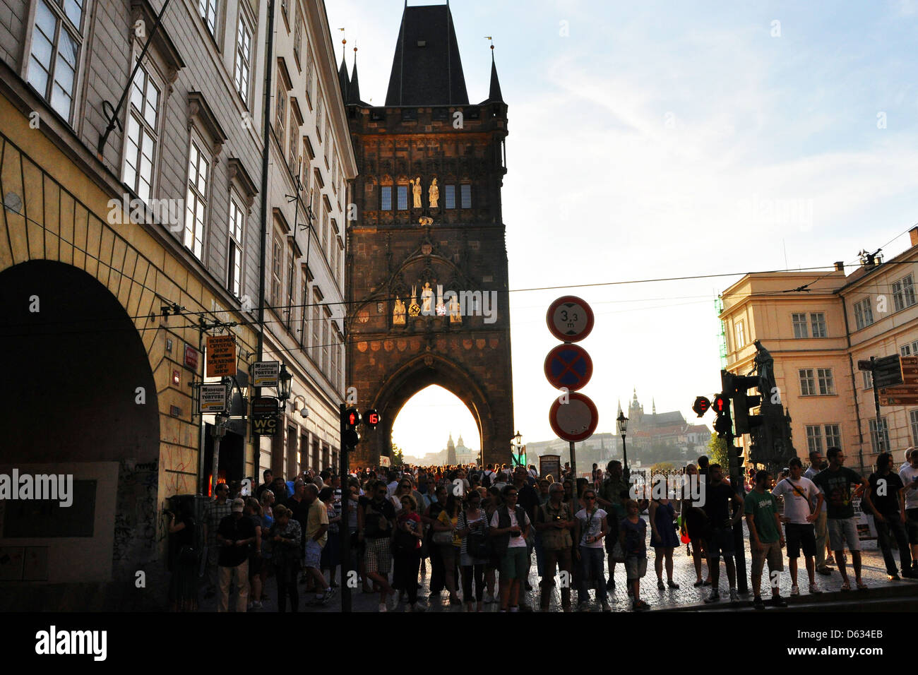 Prague packed with tourists in the late evening sun, with Old Town Bridge tower leading onto Charles Bridge. Stock Photo
