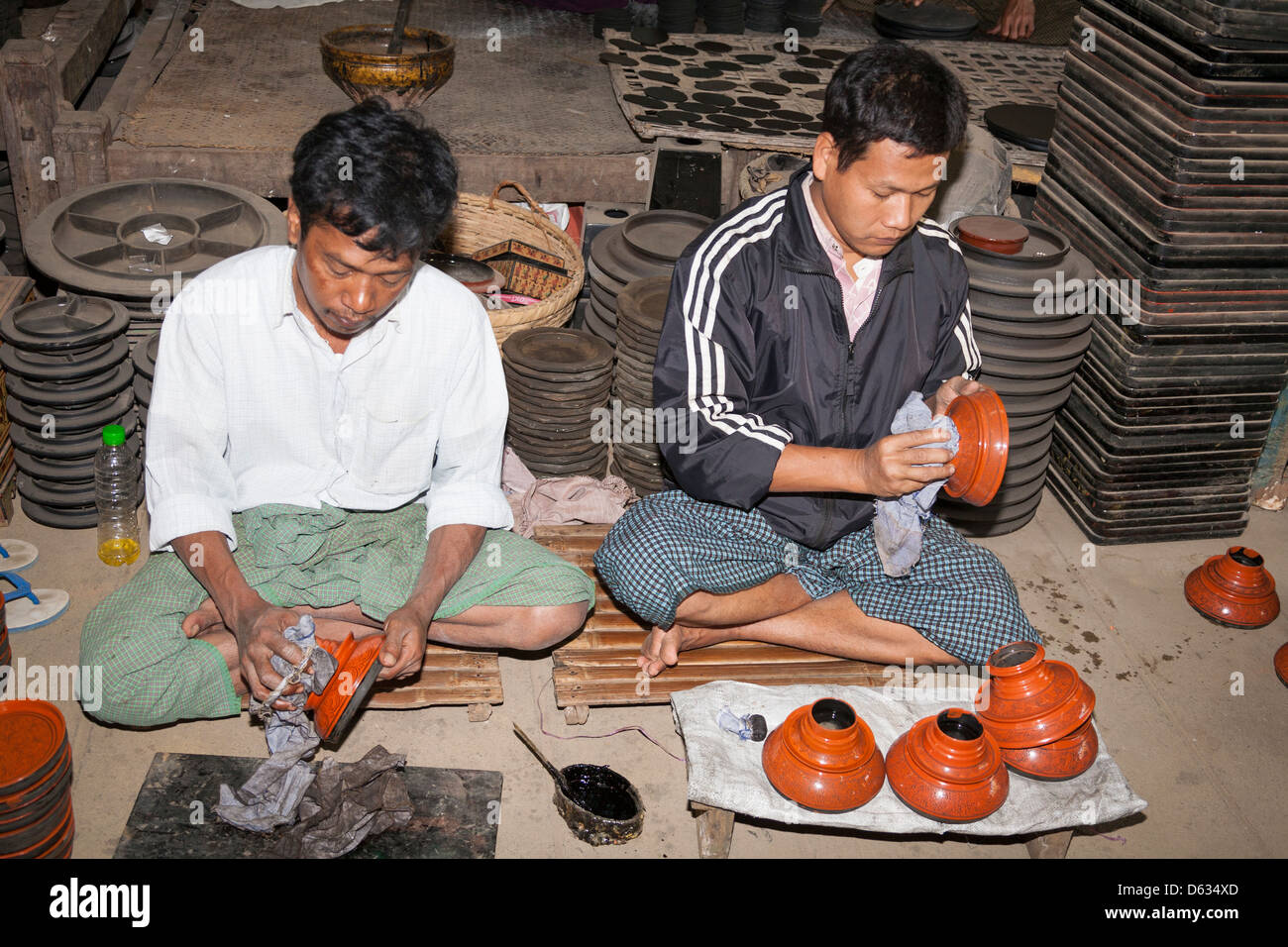 Men working in the U Ba Nyein lacquer ware factory, Myo Thit, Bagan, Myanmar, (Burma) Stock Photo
