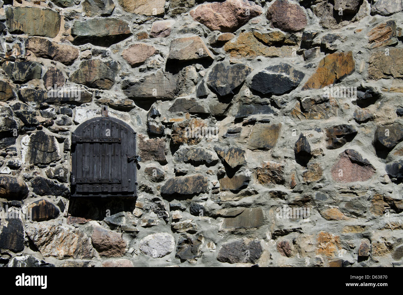Wooden window on stone wall Stock Photo - Alamy