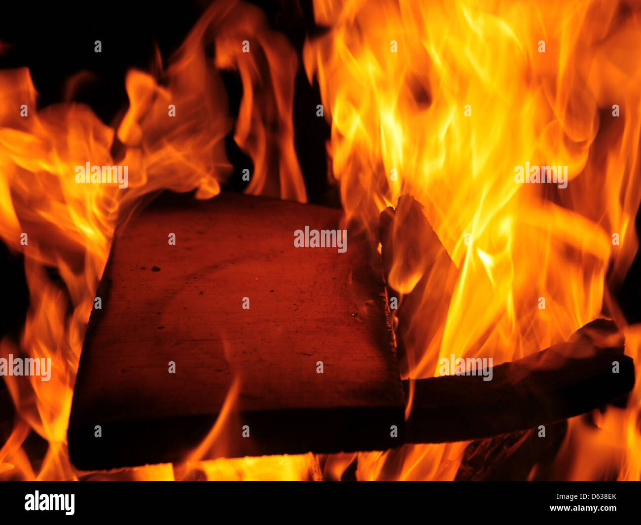 This image depicts a fire burning in the night, showcasing flames with a bright red glow. The fire's intensity is captured against the darkness, highlighting the dynamic nature of flames. Available for free use under public domain. Stock Photo
