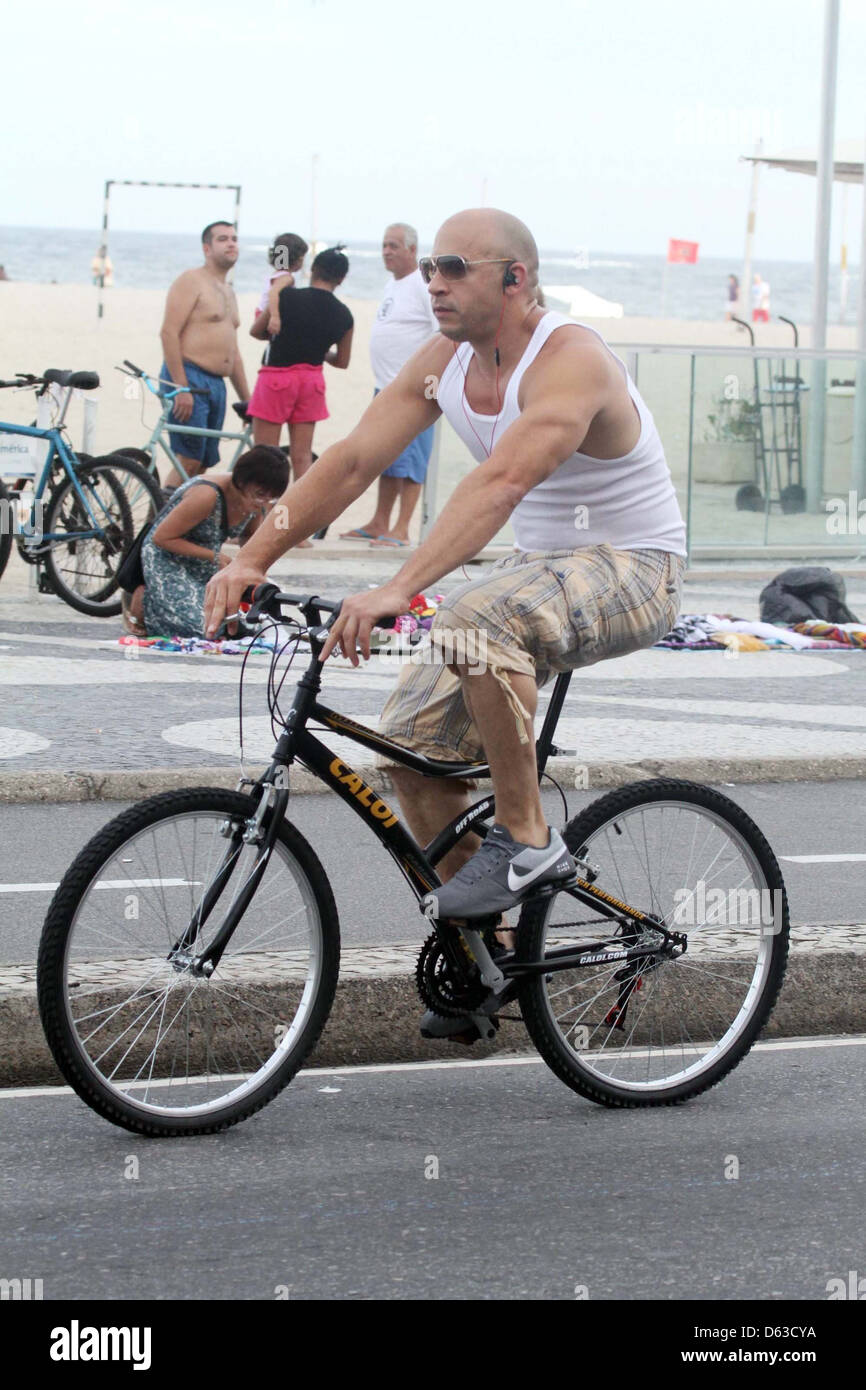 Vin Diesel tours Copacabana on a bicycle with his bodyguards Rio de  Janeiro, Brazil - 10.04.11 Stock Photo - Alamy