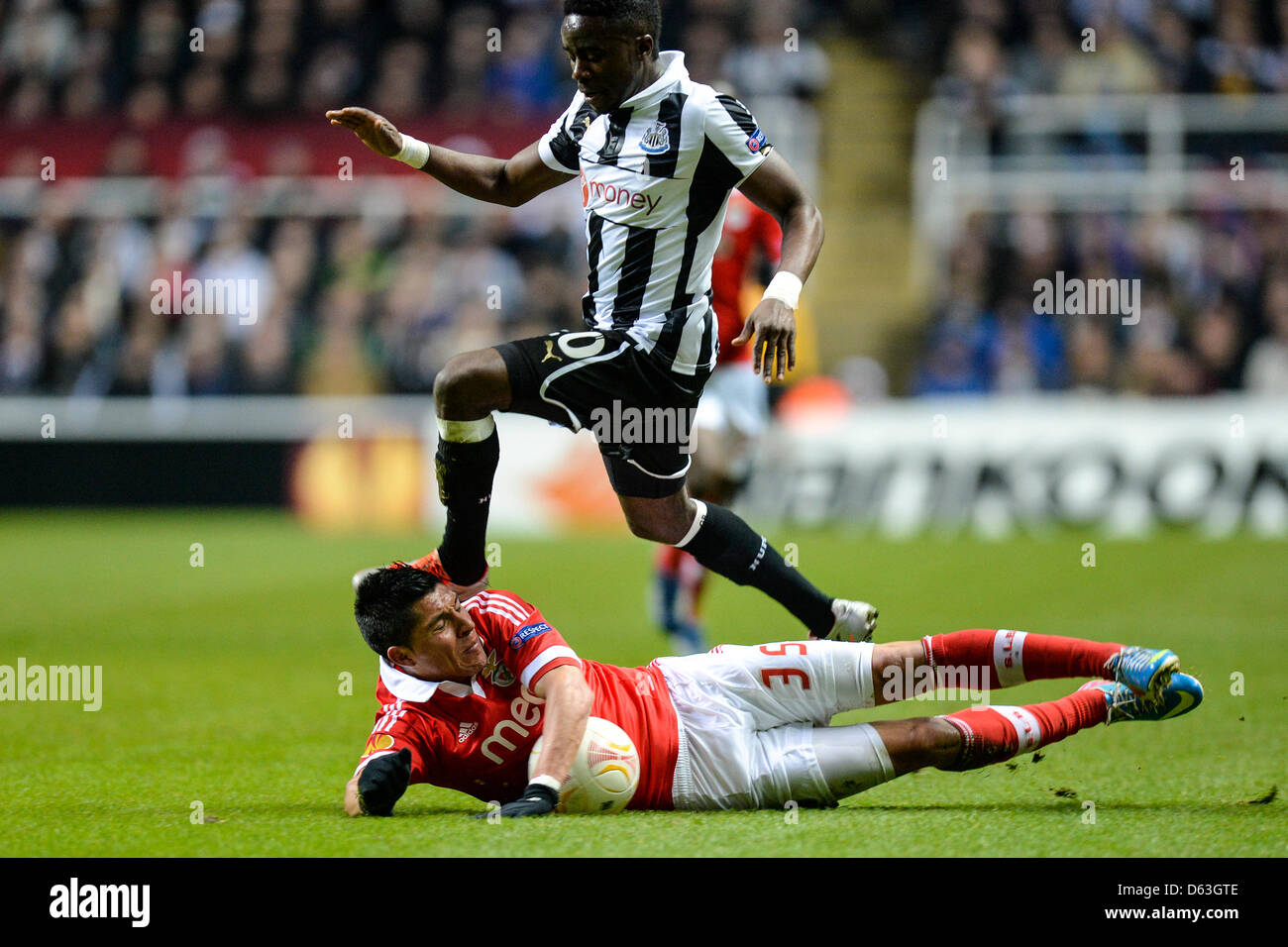 Newcastle, UK. 11th April 2013. Gael Bigirimana leaps over Enzo Perez and clips his head with his foot, giving away a free kick during the Europa League 2nd leg game between Newcastle and Benfica from St James Park. Credit: Action Plus Sports Images / Alamy Live News Stock Photo
