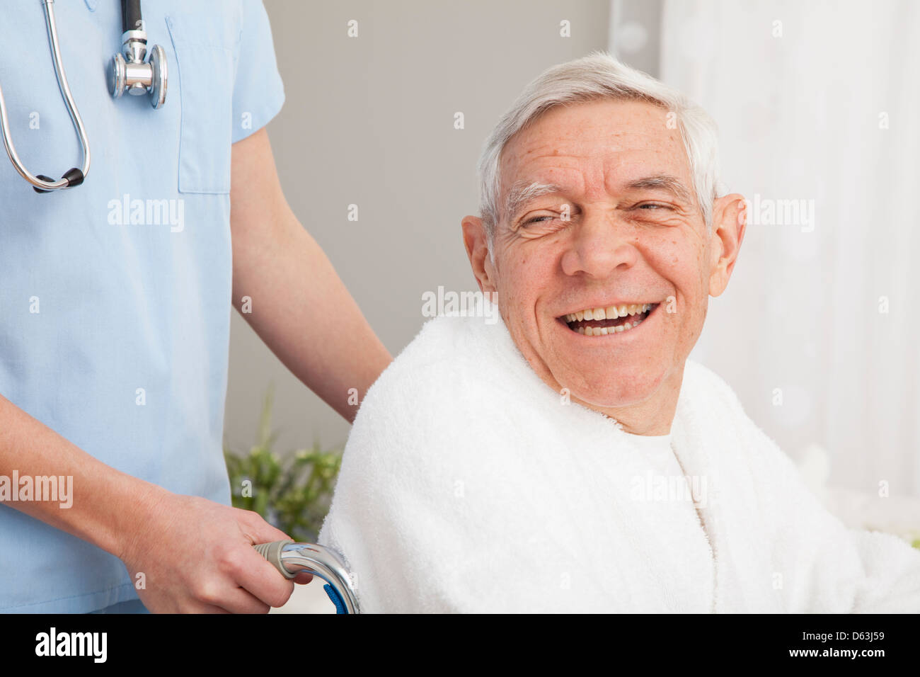 Close up of happy senior man assisted by nurse Stock Photo