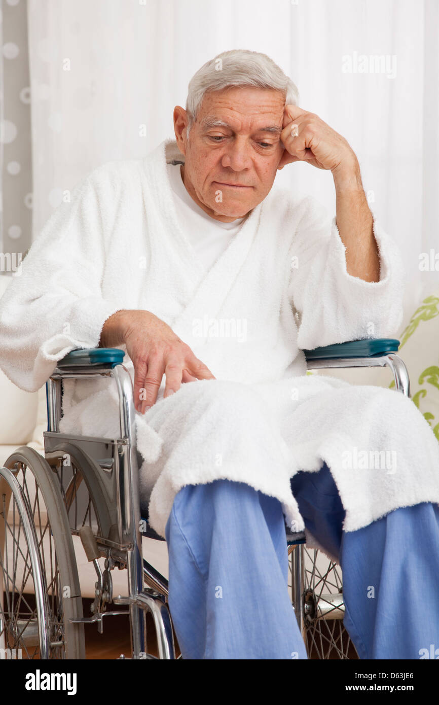 Sad senior man on wheelchair Stock Photo
