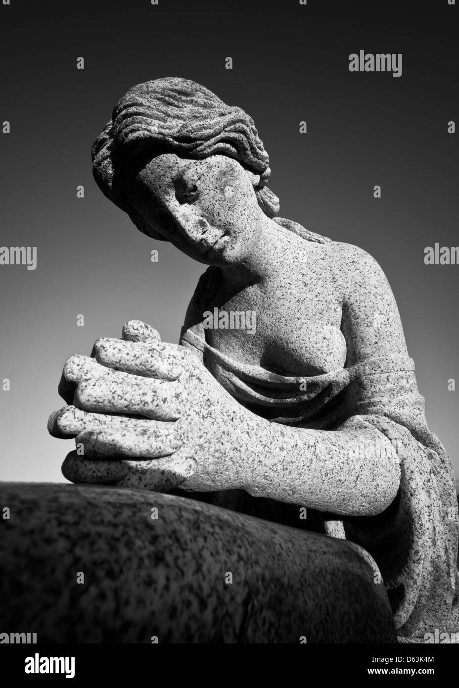 Stone statue of a woman praying in black and white, part of a gravestone Stock Photo Alamy