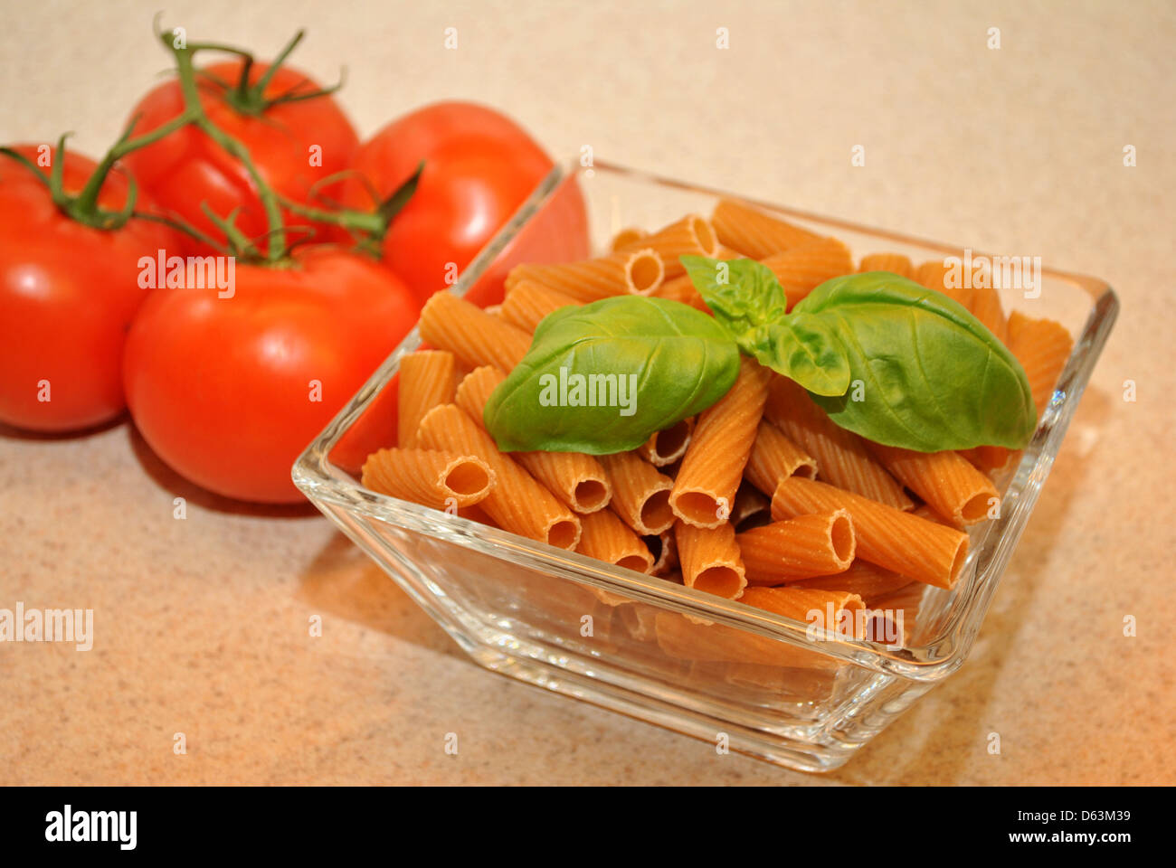 Wheat Pasta with Basil and Whole Tomatoes Stock Photo