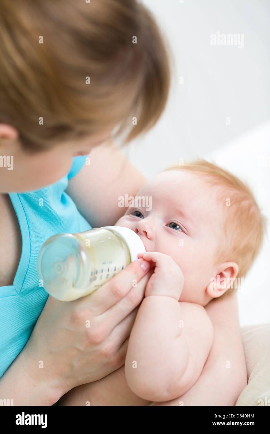 mother feeding baby from bottle Stock Photo Alamy