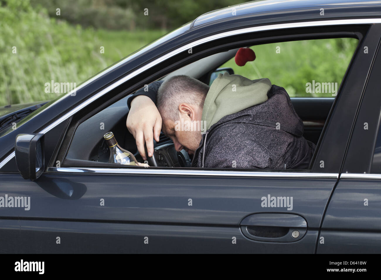 Drunk man asleep at the wheel Stock Photo