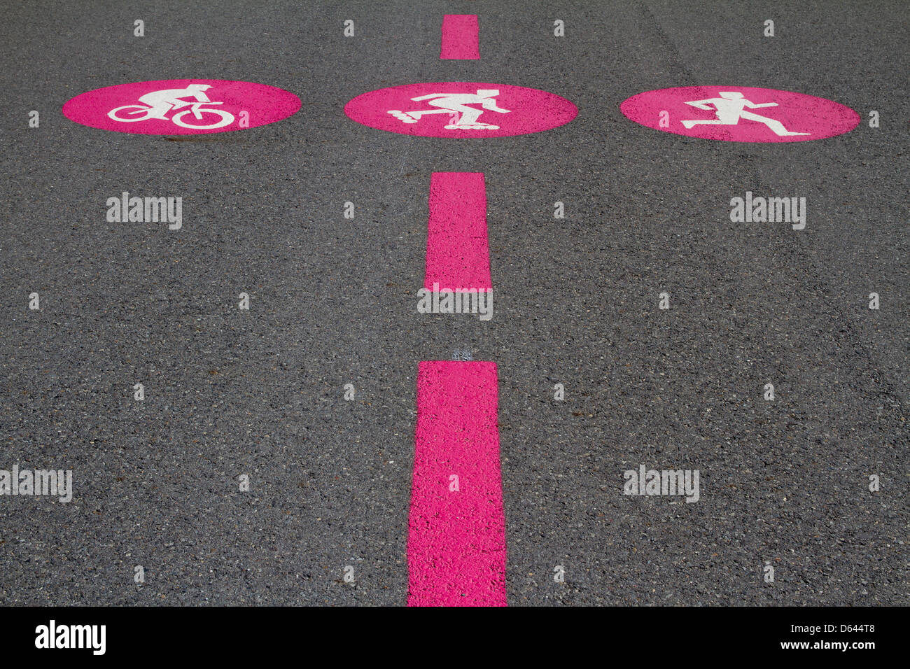 Pink pictograms of biker, skater, jogger on gray surface Stock Photo
