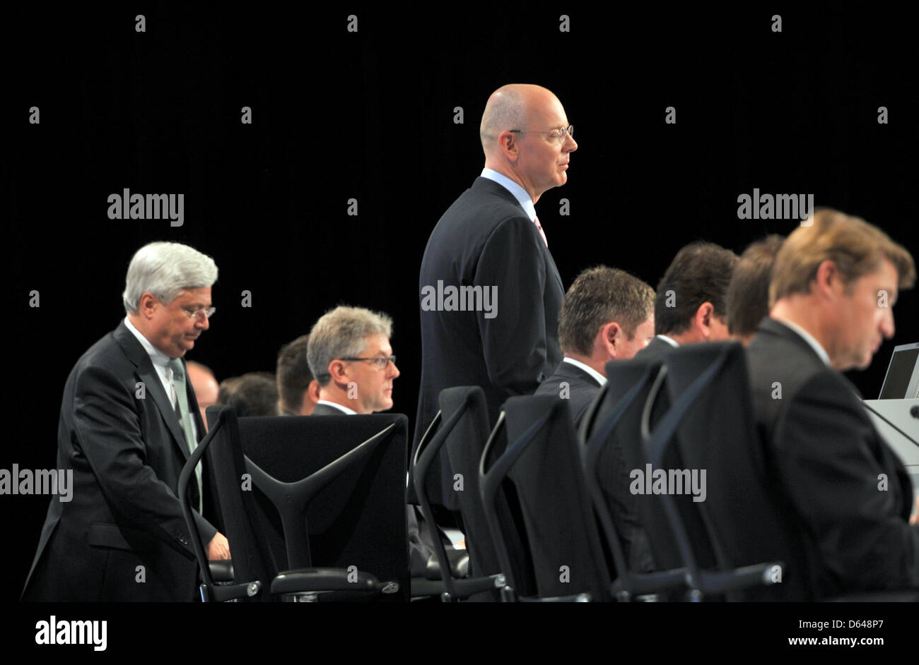 CEO of Commerzbank Ag Martin Blessing (C) speaks at the company's annual general meeting at Centennial Hall in Frankfurt Main, Germany, 23 May 2012. With him on stage are chairman of the board Klaus-Peter Mueller (LK) and other members of the board. Shareholders are not too happy: stock prices have plummeted and there will not be a dividend for the fourth year in a row. On top of t Stock Photo