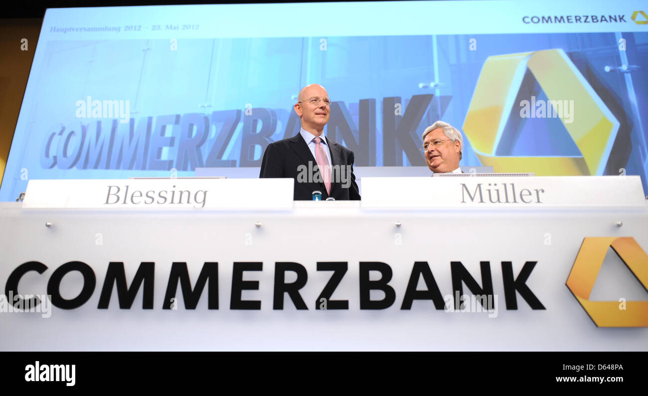 CEO of Commerzbank Ag Martin Blessing (L) and chairman of the board Klaus-Peter Mueller (R) are pictured at the start of the company's annual general meeting at Centennial Hall in Frankfurt Main, Germany, 23 May 2012. With him on stage are chairman of the board Klaus-Peter Mueller (LK) and other members of the board. Shareholders are not too happy: stock prices have plummeted and t Stock Photo