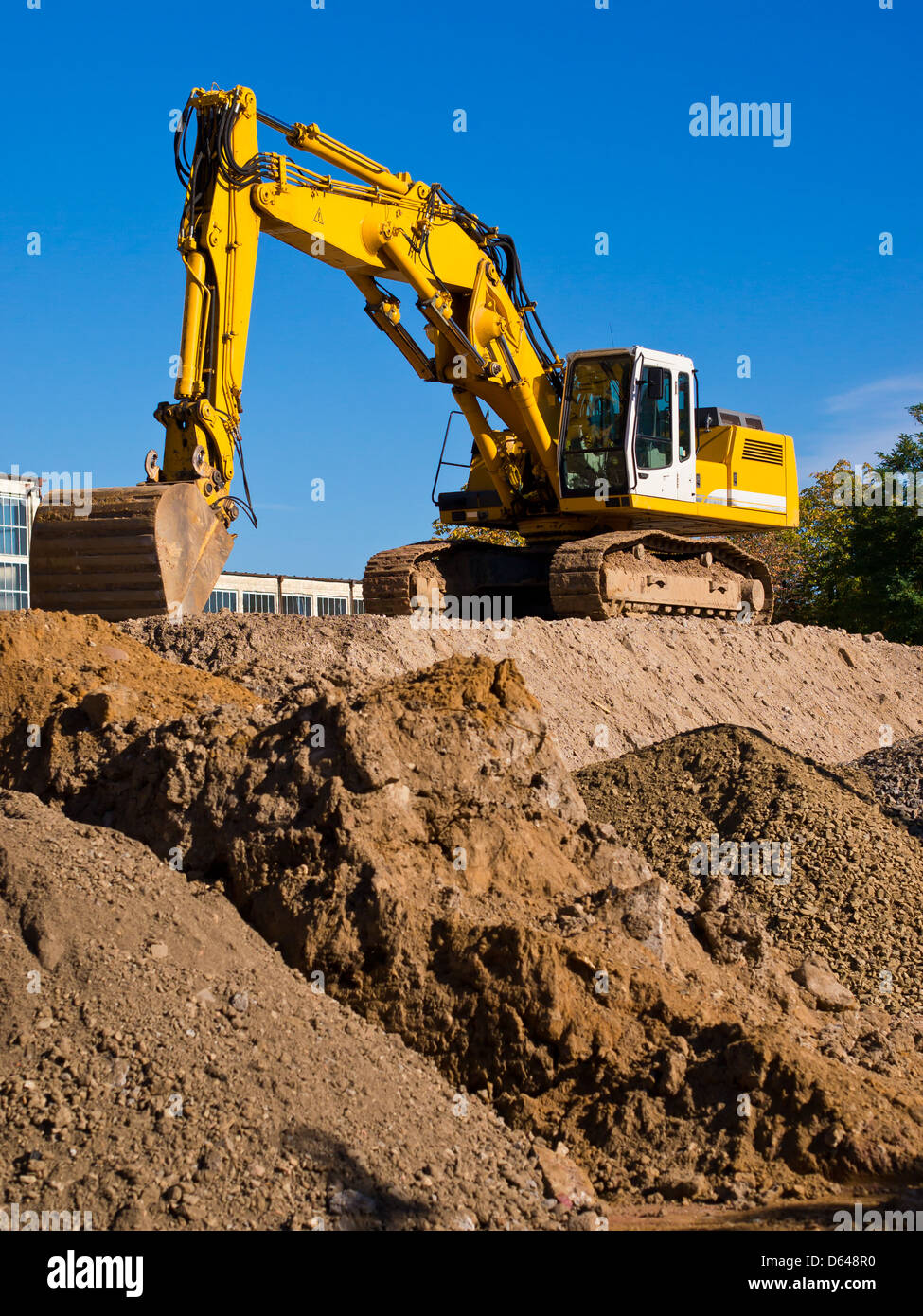 excavator machine on pile of earth Stock Photo