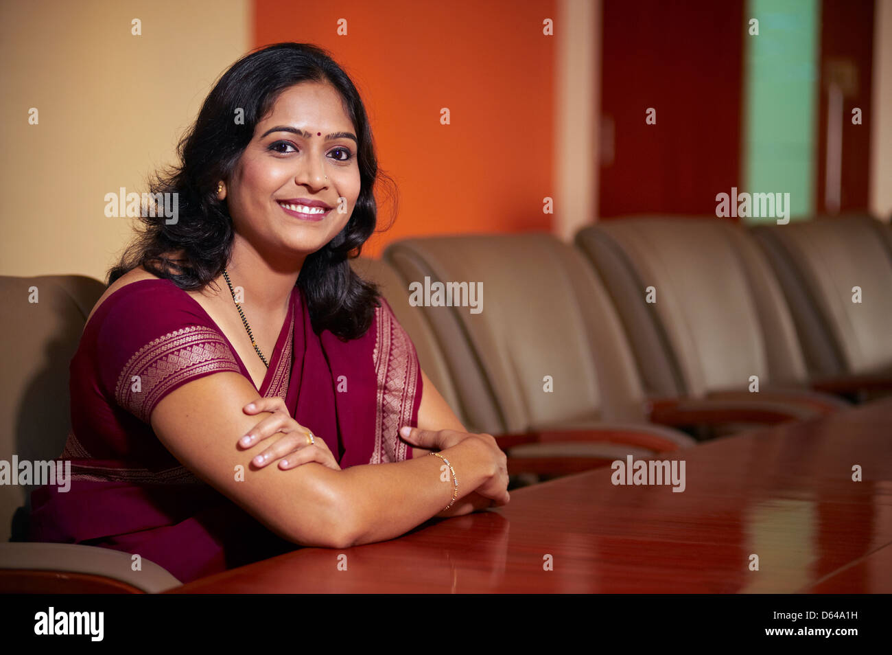 Portrait of a confident Indian business women in Indian sari smiling ...